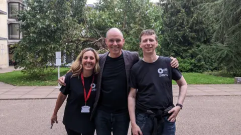 Oxford Shorts Andrew Carslaw and Laura Jones posing for a picture outside with Oscar-winning Visual Effects designer Paul Franklin.