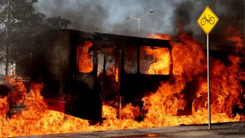 A burning bus lit with flames in Zapopan, state of Jalisco, Mexico on 22nd February
