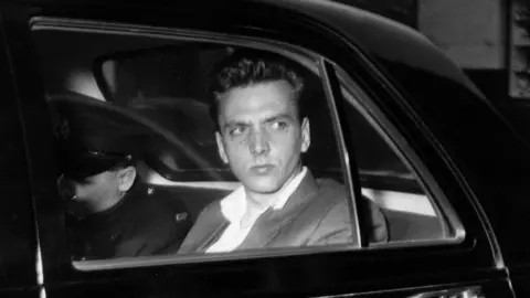 Getty Images Ian Brady travelling to a court hearing in October 1965