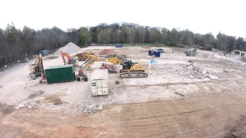 Forest of Dean District Council A drone view of the Five Acres site in Coleford with heavy machinery working to clear it