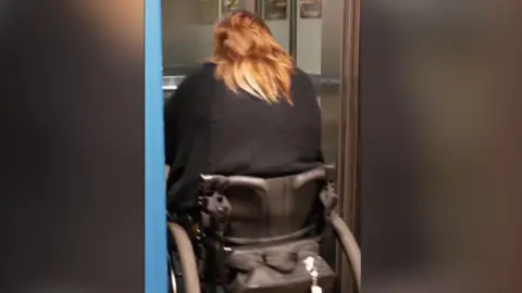 @disabled_in_norfolk Rebecca Scollay in her wheelchair trying to get into a lift in the Norwich John Lewis department store.