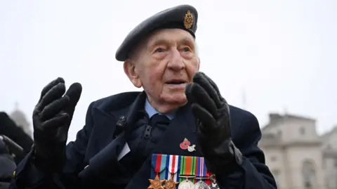 Reuters Joe Randall in an RAF beret and blazer with medals attached 