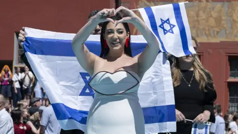 EPA Israel's Yuval Raphael posing on the turquoise carpet during the opening ceremony of the 69th Eurovision Song Contest in Basel, Switzerland