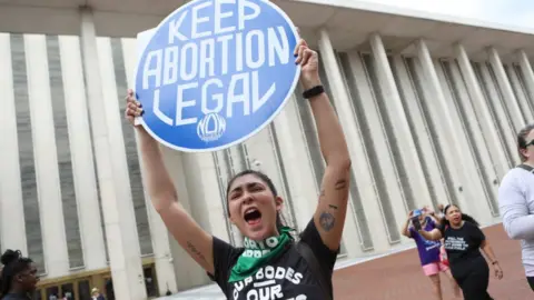 Getty Images File image of a protester holding up a sign which reads: "Keep abortion legal"