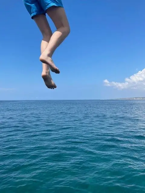 Liz Jones The legs of a person are seen as they dive into the sea