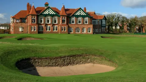 A view of a bunker in front of the 18th green at Royal Lytham & St Annes, with the clubhouse in the background