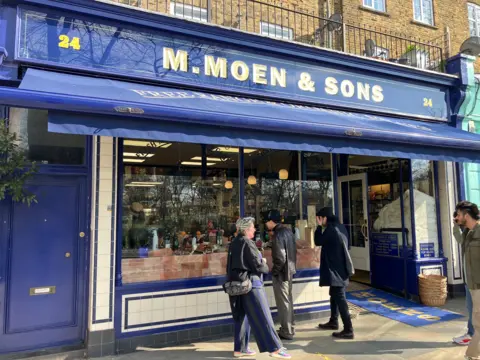 M Moen & Sons shop front with customers outside