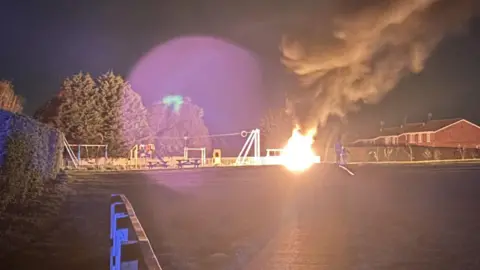 Ron Bench on fire in a park