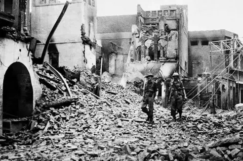 AFP This photo taken in August 1947 shows Indian soldiers walking through the debris of a building in the Chowk Bijli Wala area of Amristar during unrest following the Partition of India and Pakistan