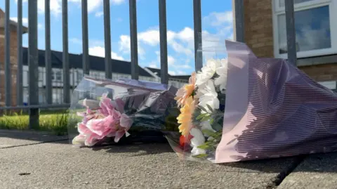 Two bouquets of flowers on the pavement