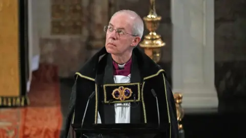 PA Justin Welby wears glasses and black robes