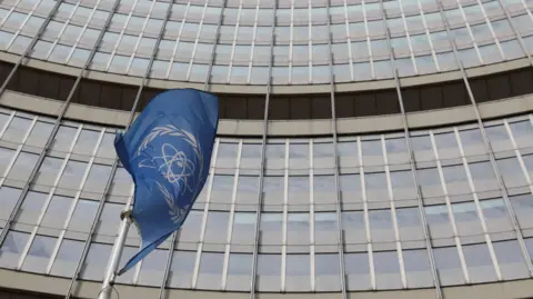 The flag of the International Atomic Energy Agency (IAEA) flutters in front of the agency's headquarters on the opening day of a quarterly meeting 