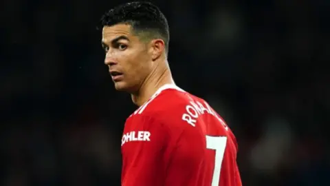 PA Media Cristiano Ronaldo, wearing United's legendary red No.7 shirt, looks over his shoulder during a game