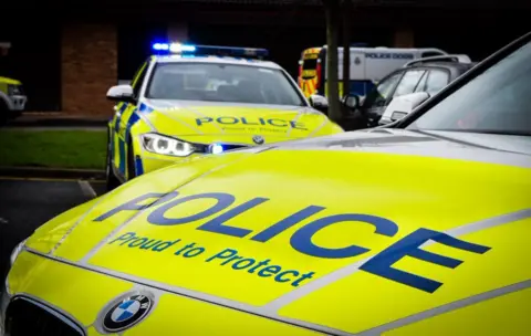 Library image of two Northumbria Police cars. They have yellow-and-blue liveries and the bonnet says "Police, Proud to Protect".