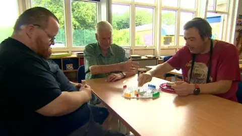 Three friends playing board games