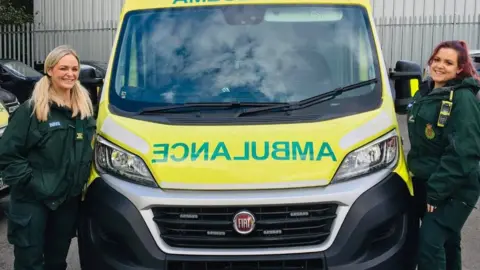 West Midlands Ambulance Service Deena Evans with crewmate Charlie as she returned to work on Thursday