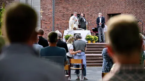 EPA-EFE Couples attend a blessing outside a Catholic church in Cologne