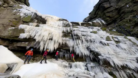Rod Kirkpatrick/RKP Photography A group of ice climbers stood below Kinder Downfall, which is a waterfall that has frozen over