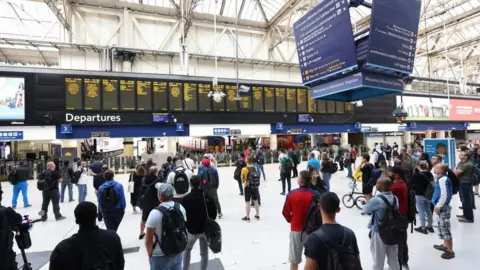 PA Media File image of passengers waiting on the concourse at Waterloo station