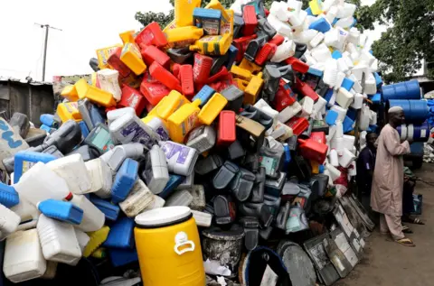 Reuters Men stand near plastic containers for sale in Abidjan, Ivory Coast November 19, 2018