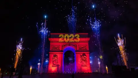 EPA A light and fireworks show displayed on the Arc de Triomphe as revellers celebrate the new year 2023 on the Champs-Elysees avenue in Paris, France, 01 January 2023.