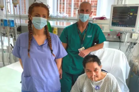 Blackpool Victoria Hospital Staff nurse Sarah Kenny, lead consultant Dr Jason Cupitt and patient Roehl Ribaya