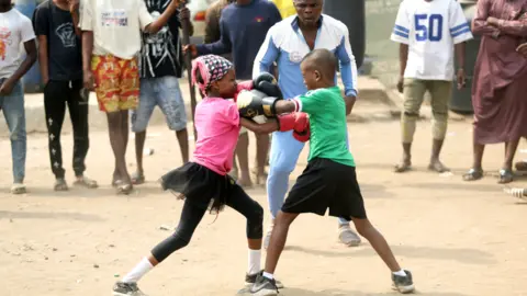 EPA A girl and boy take part in a boxing training match in Lagos, Nigeria - Saturday 5 March 2022