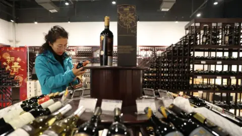 Getty Images A woman in a wine store in China