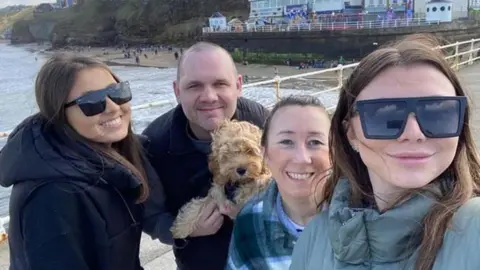 Tom Claypole with his fiancé and two daughters