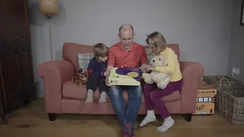 A family reading The Gruffalo with a scent kit