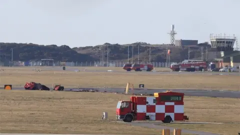 PA Media The wreckage at RAF Valley