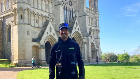 BBC Josh Patterson in front of St Albans Cathedral