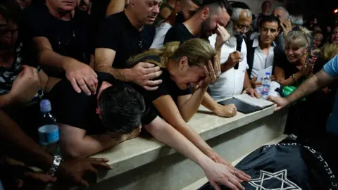 AFP Mourners at the funeral of Kim Levengrond Yehezkel, an Israeli woman who was shot at the Barkan Industrial Zone in the occupied West Bank on 7 October 2018