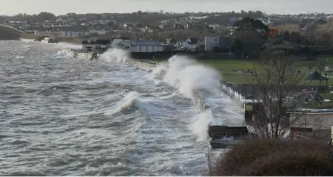 weather watchers/shaws view Stormy seas in Paignton in Torbay, waves crash against the sea wall.