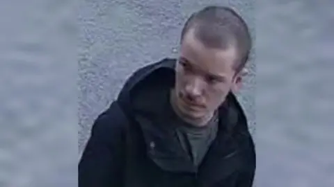 Humberside Police CCTV image of Sam. He has short dark hair and is wearing a dark jacket 