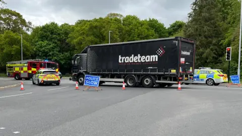The scene of a police incident where a collision between a car and lorry has taken place. 