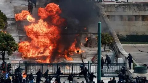 Reuters A petrol bomb explodes into flame as clashes erupt in Athens