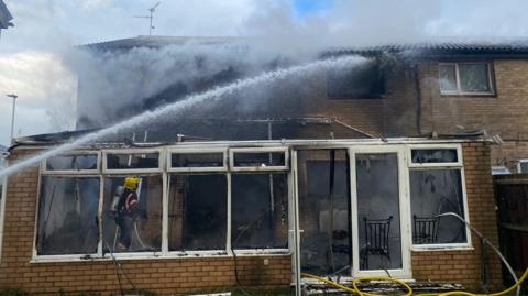 Firefighter at scene of houses on fire in Bretton