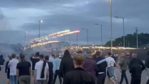 social media A crowd of people with fireworks exploding over them. 