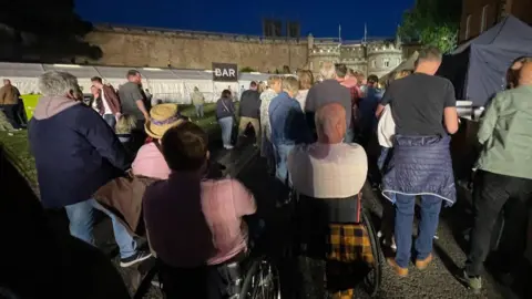 Richard Adams People in wheelchairs leaving Lincoln Castle via East Gate after the concert