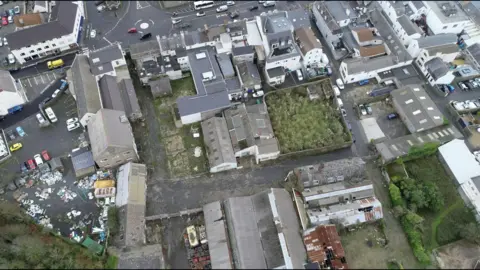 The Leale's Yard site from the air. A number of grey buildings and derelict sites. 