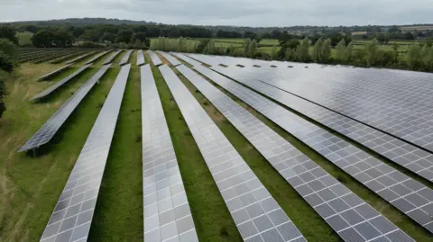 Andrew Robert/BBC A solar farm across a field in Somerset