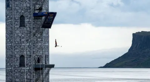 Harry Murphy/Sportsfile via Getty Images) Northern Ireland , United Kingdom - 19 July 2024; Paula Gilabert of Spain dives off the man made structure in Ballycastle