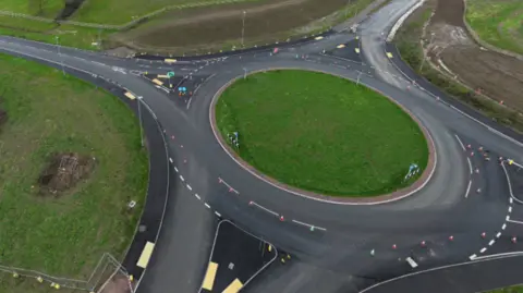 An aerial picture of a roundabout without any traffic