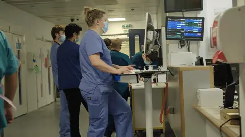 BBC NHS staff in a hospital corridor