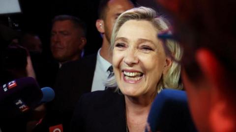 Marine Le Pen, French far-right leader and far-right Rassemblement National (National Rally - RN) party candidate, speaks to journalists after partial results in the first round of the early French parliamentary elections in Henin-Beaumont, France, June 30, 2024