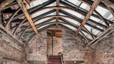 Historic England handout Interior view of the inn at first-floor level, showing the frame supporting the barrel vaulted roof.