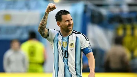 Lionel Messi raises his fist to the air