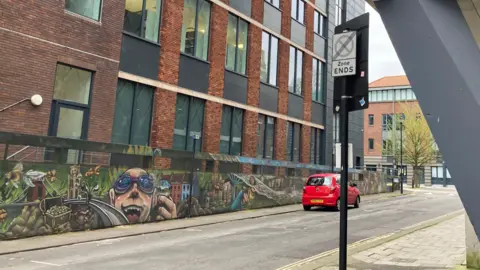 Assembly Rooms Lane in Bristol on an overcast day.