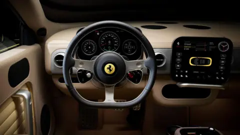 Ferrari An inside look of the Ferrari Luce, with cream leather lining and a large touchscreen with curved edges.